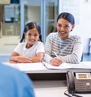 Mother and daughter checking in at reception