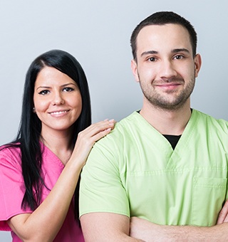 Two smiling team members