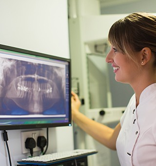 Dental team member looking at x-rays