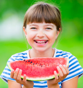 girl smiling braces watermelon