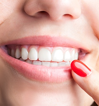 Woman pointing to healthy smile