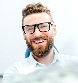 man smiling wearing glasses