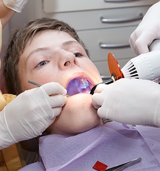 Patient receiving dental sealants