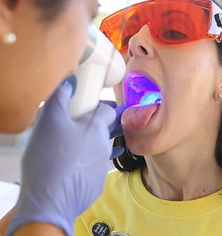 Woman receiving oral cancer screening