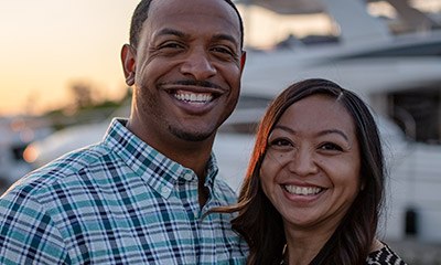 Smiling man and woman outdoors