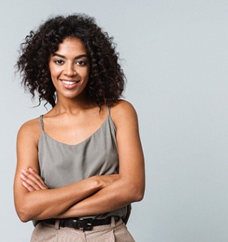 person with crossed arms smiling