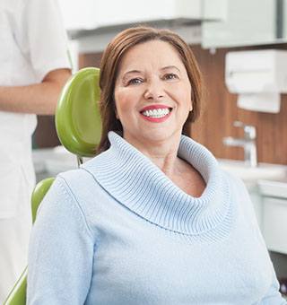 Smiling older woman in dental chair