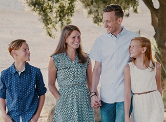 Smiling parent and children outdoors