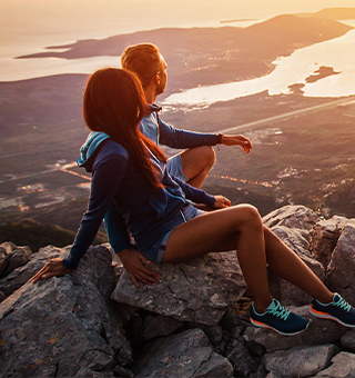 Two people on top of a mountain